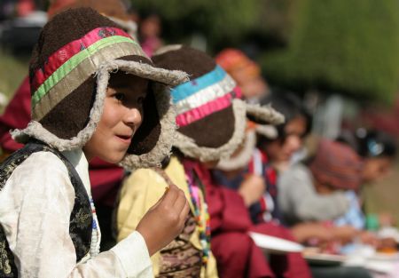 A Nepalese child wearing a traditional dress attends an event to mark the Universal Children's Day at the presidential palace in Kathmandu, capital of Nepal, Nov. 20, 2009. Nepal celebrated the Universal Children's Day with various programs across the country on Friday. (Xinhua/Bimal Gautam)