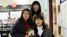 Kelly Ye-Won Kim (L) poses for a photo with her teacher at the Fieldstone Day School in Toronto, Canada, on November 20, 2009. The 10-year-old girl Kelly had a lot of fun at the Rainforest Cafe celebrating the Universal Children's Day with her family members on Friday.