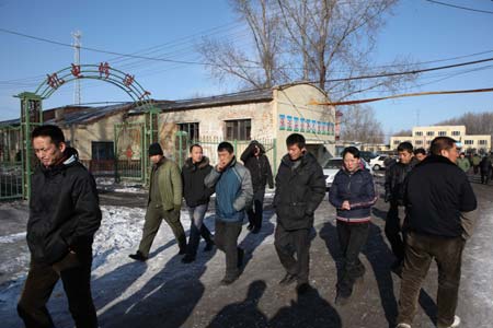 Relatives of coal miners come to the accident site to wait for further information in the Xinxing Coal Mine owned by the Heilongjiang Longmei Mining Holding Group in Hegang City, northeast China's Heilongjiang Province, November 21, 2009.