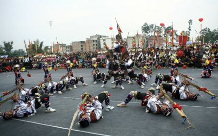 Performers play the lusheng musical pipe during the Lusheng and Horse Fight Festival held in the Sports Park in Rongshui Miao Autonomous County, southwest China's Guangxi Zhuang Autonomous Region, November 21, 2009. 