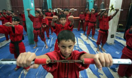 Palestinian children practise Kungfu during martial arts training class at the Red Dragon School in Beit Lahiyathe Town, northern Gaza, Palestine, November 21, 2009. Over 10 clubs like Red Dragon Scholl teach martial arts in Gaza. Each of them has more than 150 members.