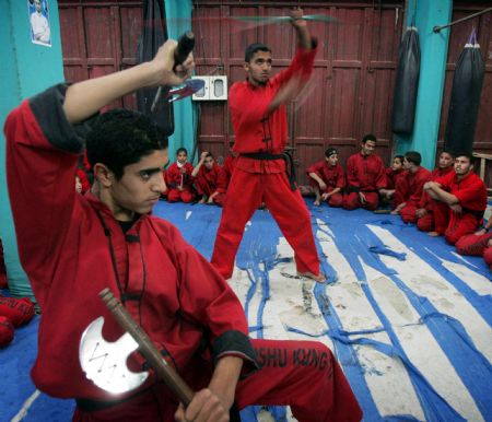 Palestinian children practise Kungfu during martial arts training class at the Red Dragon School in Beit Lahiyathe Town, northern Gaza, Palestine, November 21, 2009.