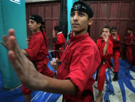 Palestinian children practise Kungfu during martial arts training class at the Red Dragon School in Beit Lahiyathe Town, northern Gaza, Palestine, November 21, 2009.