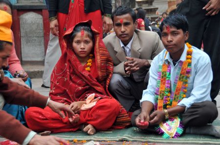 A bride and a bridegroom sit during their wedding ceremony in a temple in Kathmandu, capital of Nepal, on November 21, 2009. According to the Nepali calendar, it is inappropriate for people to get married in the first seven months of a year. 