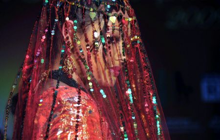 A model presents traditional Nepali wedding dress in a temple in Kathmandu, capital of Nepal, on November 21, 2009.