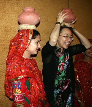 A Chinese youth learn Indian traditional dance from an Indian youth during a party in Ahmadabad, India, November 24, 2009.