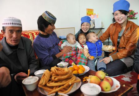 A family of muslims enjoy themselves at home to celebrate the Corban Festival, or Eid Al-adha in Tongxin County, northwest China's Ningxia Hui Autonomous Region, November 27, 2009.