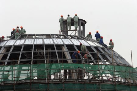 Workers proceed on a building site of the 2010 Shanghai World Expo in Shanghai, east China, November 29, 2009. Most of the pavilions are taking on a dashing look with the coming of the 2010 Shanghai World Expo, which will fall in May of next year.