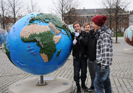 People look at globes displayed as part of an exhibition prior to the UN Climate Change Conference in Copenhagen, capital of Denmark, on November 21, 2009.