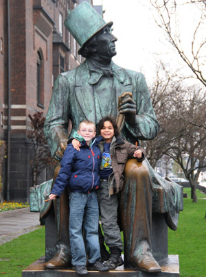 Photo taken on November 22, 2009 shows children posing for a photo with the statue of Danish author Hans Christian Andersen in Copenhagen, capital of Denmark.