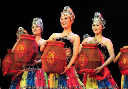 Dancers perform in the Song and Dance Pageant on Affection with the Homeland of Yao Ethnic Group, in the Grand Theatre of Hezhou City, southwest China's Guangxi Zhuang Autonomous Region, December 1, 2009.