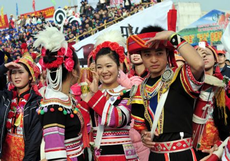 Girls of Yao ethnic group present pieces of traditional embroidery during the opening ceremony of the 2009 China (Hezhou) Panwang Festival in Hezhou, southwest China's Guangxi Zhuang Autonomous Region, on December 2, 2009. 