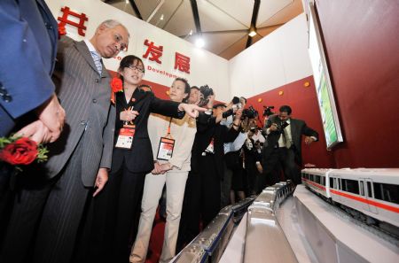 Visitors view Chinese subway train models during an exhibition showcasing Chinese innovative technologies and products in Cairo, capital of Egypt, on December 3, 2009.