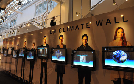 A man walks past UN Climate Wall prior to the 15th United Nations Climate Change Conference (COP15) at Bella Center in Copenhagen, capital of Demark, December 6, 2009. The conference will be held from December 7 to 18.