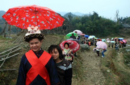 Li Zhengqian, father of a five-year-old son, is on his way back home of his wife Pan Libin to hold wedding ceremony, in Tonglian Village of Rongshui Miao Autonomous County, southwest China's Guangxi Zhuang Autonomous Region, December 6, 2009.