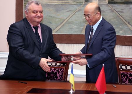 Chinese ambassador to Ukraine Zhou Li (R) and Ukraine's Deputy Minister of Health Igor Yakovenko exchange documents in Kiev, capital of Ukraine, December 7, 2009. The Chinese embassy in Ukraine signed a document with the Ukraine government here on Monday to allocate free aid worth of a total of 3.5 million yuan (about US$500,000) to help Ukraine combat the A/H1N1 flu epidemic.