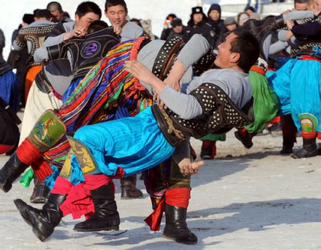 Participants present a wrestling during the opening of the winter Nadam fair in Hailar, north China's Inner Mongolia Autonomous Region, December 8, 2009.