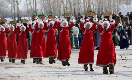 Participants perform a dance during the opening of the winter Nadam fair in Hailar, north China's Inner Mongolia Autonomous Region, December 8, 2009.