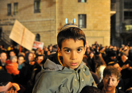 An Israeli boy joins the thousands in a rally protesting against settlement freeze at Paris Square in Jerusalem, December 9, 2009. 