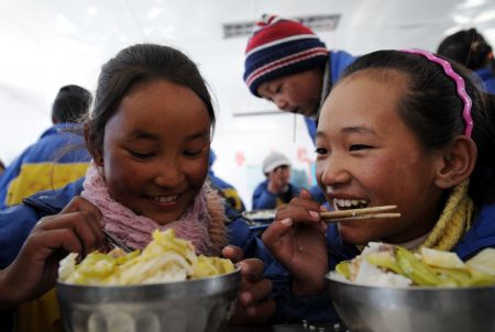 Pupils play during a break at the Complete Primary School of Bomdoi Township in Dagze County, southwest China&apos;s Tibet Autonomous Region, December 9, 2009. 
