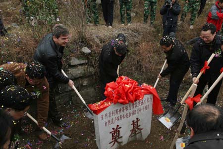 Distinguished guests shovel earth to the foundationstone during the foundation-laying ceremony of the sub-item to Guanling under the World Bank Loans to Guizhou Province For Cultural and Natural Heritages Protection and Development Program, in the Geological Park of Guanling Bouyei and Miao Autonomous County, southwest China's Guizhou Province, December 8, 2009.