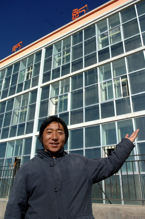 A teacher shows the dormitories which use solar energy for its heating devices at a primary school in a village in Tibetan Autonomous Prefecture of Huangnan in northwest China&apos;s Qinghai Province, December 2, 2009.