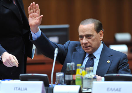 Italian Prime Minister Silvio Berlusconi greets other leaders during the EU summit at the EU headquarters in Brussels, capital of Belgium, December 10, 2009.