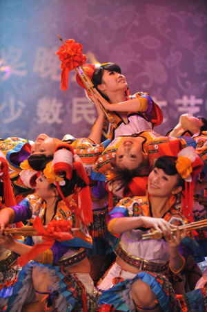 Actresses present a performance of Miao ethnic group during the closing ceremony of Guizhou Minority Culture and Art Show in Kaili, southwest China's Guizhou Province, December 10, 2009.