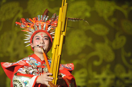 An actor presents a performance of Miao ethnic group during the closing ceremony of Guizhou Minority Culture and Art Show in Kaili, southwest China's Guizhou Province, December 10, 2009.