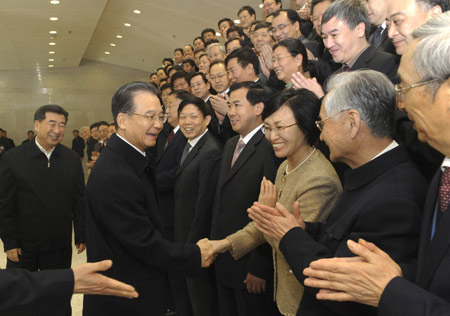 Chinese Premier Wen Jiabao (2nd L) meets with climate experts and workers at the National Climate Center while visiting China Meteorological Administration in Beijing, capital of China, December 11, 2009.