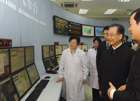 Chinese Premier Wen Jiabao (2nd R) visits the Chinese Central Meteorological Station of China Meteorological Administration in Beijing, capital of China, December 11, 2009.