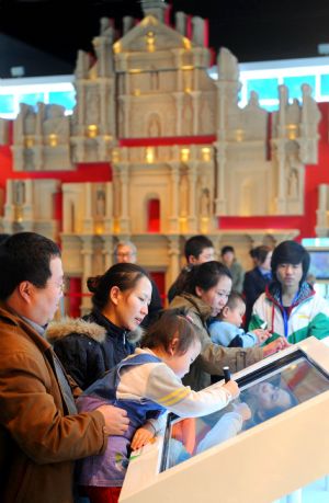 People visit an exhibition of the achievements of the Macao Special Administrative Region (SAR) over the past decade, at the Capital Museum in Beijing, December 12, 2009.