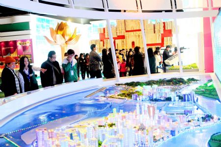 People visit an exhibition of the achievements of the Macao Special Administrative Region (SAR) over the past decade, at the Capital Museum in Beijing, December 12, 2009.