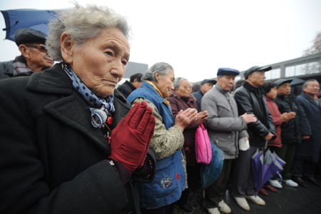 Some survivors of the Nanjing Massacre and their relatives attend a religious assembly to mourn people killed by invading Japanese troops 72 years ago in the Nanjing Massacre in Nanjing, capital of east China's Jiangsu Province, December 13, 2009.