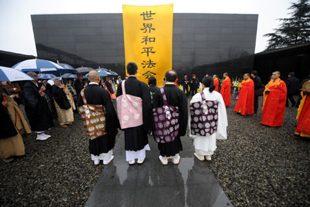 Chinese and Japanese monks hold a religious assembly to mourn people killed by invading Japanese troops 72 years ago in the Nanjing Massacre in Nanjing, capital of east China's Jiangsu Province, December 13, 2009. 