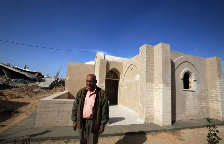 Majed al-Athamna stands before his newly-built house in northeast Gaza Strip, December 12, 2009.