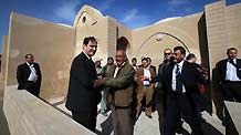 John Ging (1st L front), director of the UN Relief and Works Agency (UNRWA), talks with Majed al-Athamna (2nd L front) as he handed a new house to Majed's family in northeast Gaza Strip, December 12, 2009.