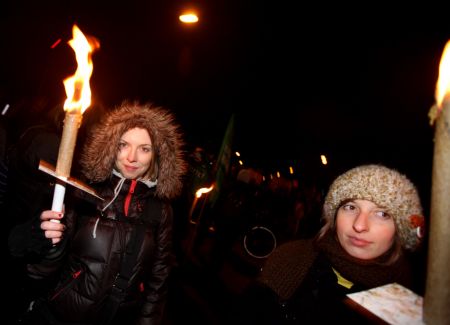 People hold torches as they take part in a rally, in Copenhagen, Denmark, December 12, 2009.
