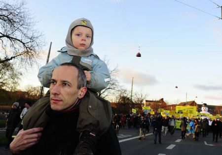 A child rides on a man's shoulders during an environmental rally in Copenhagen, Denmark, December 12, 2009.