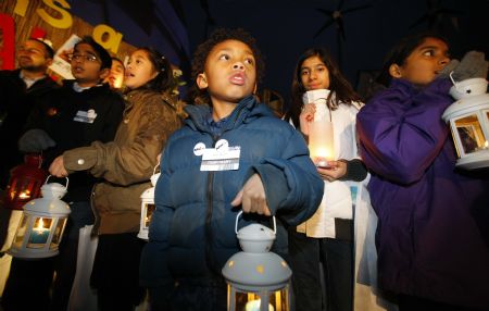 Children take part in a vigil reminding people to pay attention to the global warming, at Bella Center, the venue of the UN climate change conference, on the outskirts of the Danish capital Copenhagen, December 12, 2009.