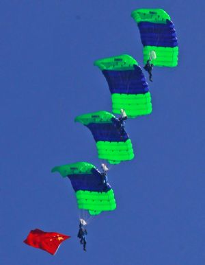 Members of the Bayi (August 1) Parachute Jumping Team of the Air Force of the Chinese People's Liberation Army (PLA) perform to celebrate the 10th anniversary of Macao's return to China, in Macao, south China, December 13, 2009. 