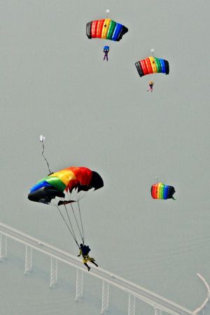 Members of the Bayi (August 1)Parachute Jumping Team of the Air Force of the Chinese People's Liberation Army (PLA) perform to celebrate the 10th anniversary of Macao's return to China, in Macao, south China, December 13, 2009. 