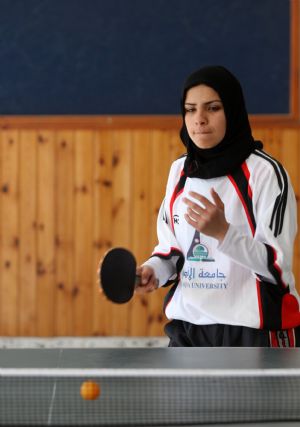 A Palestinian woman plays table tennis in a competition among women in the Hamas-run Gaza Strip on December 13, 2009.