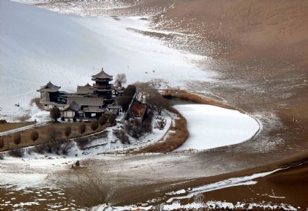 Photo taken on December 14, 2009 shows the snow scene in Yueyaquan Spring (Crescent Spring) near Mingshashan, famouse tourists attractions in Dunhuang of northwest China&apos;s Gansu Province.