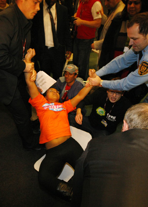 Activists are evacuated by security from the plenary hall of the Bella Center during a sit-in demonstration, Copenhagen, December 16,2009.