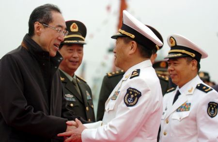 Henry Tang Ying-yen (L), the Chief Secretary for Administration of China's Hong Kong Special Administrative Region, shakes hands with Wang Zhiguo, commander of the Chinese naval 3rd escort fleet, during a seeing-off ceremony in Hong Kong, south China, on December 17, 2009. 