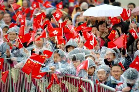 Local citizens wave goodbye to Chinese missile frigates during a seeing-off ceremony in Hong Kong, south China, on December 17, 2009. 