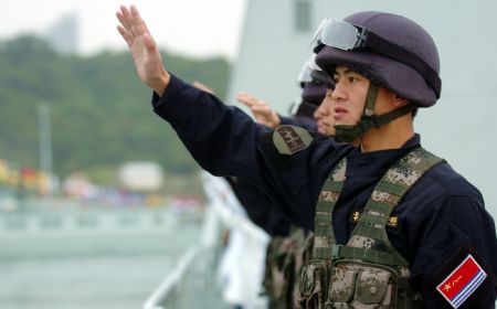 Chinese naval soldiers wave goodbye to local citizens during a seeing-off ceremony in Hong Kong, south China, on December 17, 2009. 