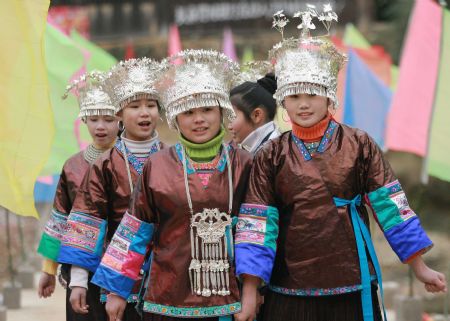 Girls of the Miao ethnic group attend new year observing activities in festive costumes in Rongshui Miao Autonomous County of southwest China's Guangxi Zhuang Autonomous Region, Dec. 17, 2009.(Xinhua/Wang Zhongkang)