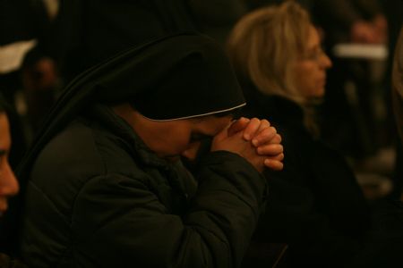 A nun prays during a mass headed by the Latin Patriarch Fuad Twal at the Latin Chur36ch in the West Bank city of Beit Sahour near Bethlehem on December 19, 2009. 